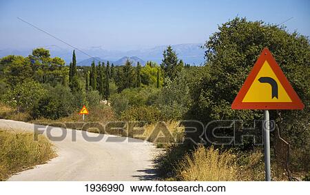 Stock Image - Road Signs Along A Curve In The Road; Ithaca Greece. Fotosearch