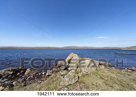 Stock Image - Rocks On The Coastline; Shetland Scotland. Fotosearch