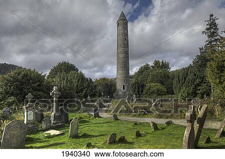 Stock Image - Round Tower In A Graveyard; Glendalough County Wicklow Ireland. Fotosearch