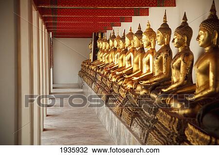 Stock Image - Seated Golden Buddha Statues In A Row At Wat Pho, Temple Of The Reclining Buddha; Bangkok, Thailand. Fotosearch