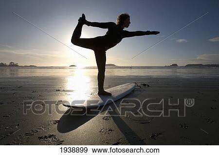 Silhouette Of Female Surfer Doing Bow Pulling Yoga Pose; Chesterman Beach Tofino Vancouver Island British Columbia Canada View Large Photo Image Stock Photo - Silhouette Of Female Surfer Doing Bow Pulling Yoga Pose; Chesterman Beach Tofino Vancouver Island British Columbia Canada. Fotosearch