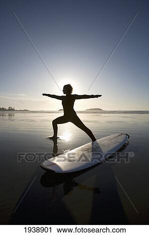 Silhouette Of Female Surfer Doing Warrior Yoga Pose; Chesterman Beach Tofino Vancouver Island British Columbia Canada View Large Photo Image Stock Image - Silhouette Of Female Surfer Doing Warrior Yoga Pose; Chesterman Beach Tofino Vancouver Island British Columbia Canada. Fotosearch