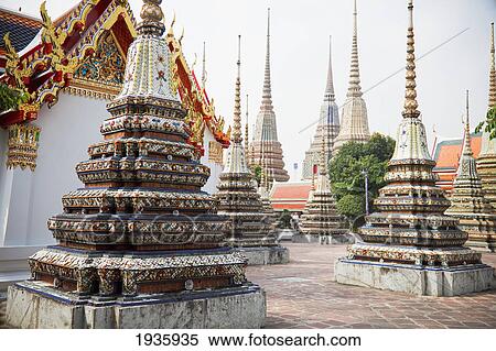Spires At Wat Pho, Temple Of The Reclining Buddha; Bangkok, Thailand View Large Photo Image Stock Photography - Spires At Wat Pho, Temple Of The Reclining Buddha; Bangkok, Thailand. Fotosearch
