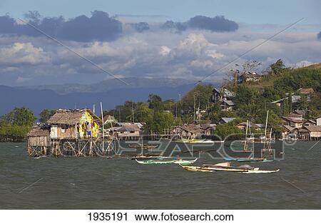Stock Image - Stilt Houses Sit Above The Water; Bais, s, Philippines. Fotosearch