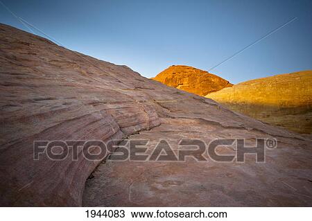 Sunlight Shining On Red Rock With A Blue Sky Above; Nevada United States Of America View Large Photo Image Stock Image - Sunlight Shining On Red Rock With A Blue Sky Above; Nevada United States Of America. Fotosearch