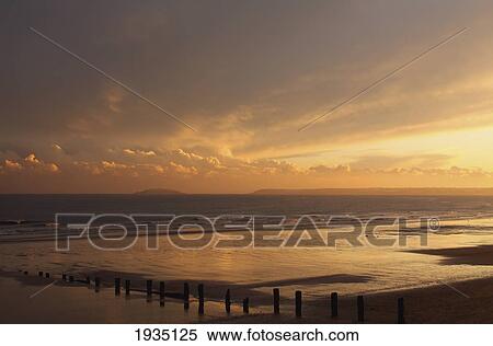 Sunset Over Beach In Winter; Youghal Beach, East Cork, Ireland View Large Photo Image Stock Photography - Sunset Over Beach In Winter; Youghal Beach, East Cork, Ireland. Fotosearch