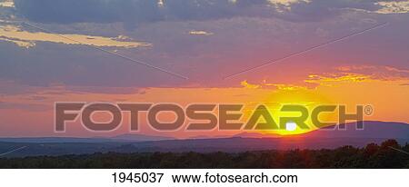 Stock Photo - sunset over the horizon; ville de lac brome quebec canada. Fotosearch