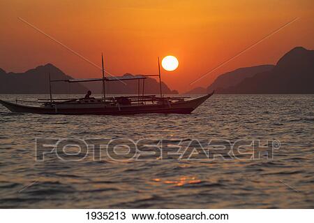 Sunset View Of Tropical Islands And A Boat From The Beaches Of Corong Corong Near El Nido; Bacuit Archipelago, Philippines View Large Photo Image Stock Image - Sunset View Of Tropical Islands And A Boat From The Beaches Of Corong Corong Near El Nido; Bacuit Archipelago, Philippines. Fotosearch