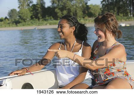 Teenage Girls Sitting In A Boat Pointing And Laughing; Troutdale Oregon United States Of America View Large Photo Image Stock Photograph - Teenage Girls Sitting In A Boat Pointing And Laughing; Troutdale Oregon United States Of America. Fotosearch
