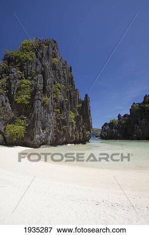 The Crystal Clear Waters Of The Small Lagoon; Miniloc Island, El Nido, Bacuit Archipelago, Palawan, Philippines View Large Photo Image Stock Photo - The Crystal Clear Waters Of The Small Lagoon; Miniloc Island, El Nido, Bacuit Archipelago, Palawan, Philippines. Fotosearch