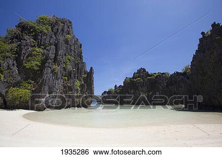 Stock Photograph - The Crystal Clear Waters Of The Small Lagoon; Miniloc Island, El Nido, Bacuit Archipelago, Palawan, Philippines. Fotosearch