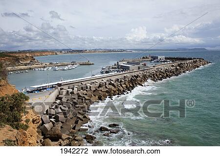 Stock Image - The Pier At The Harbor; Conil Andalusia Spain. Fotosearch