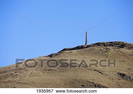 The Tip Of A Spire Behind A Hill Against A Blue Sky; Dumfries Scotland View Large Photo Image Stock Photo - The Tip Of A Spire Behind A Hill Against A Blue Sky; Dumfries Scotland. Fotosearch