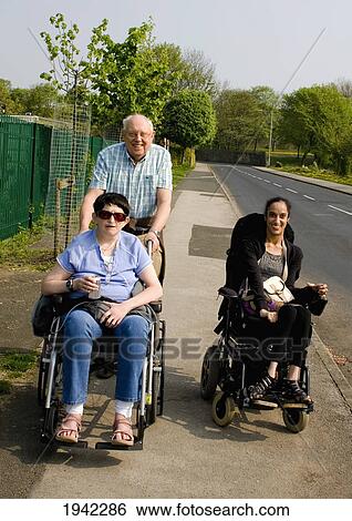 Three Friends Taking A Stroll On The Sidewalk; Bolton Lancashire England View Large Photo Image Stock Photograph - Three Friends Taking A Stroll On The Sidewalk; Bolton Lancashire England. Fotosearch