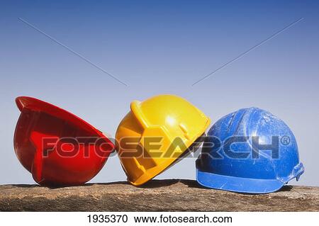 Three Hard Hats In A Row In Primary Colors Red, Yellow And Blue View Large Photo Image Stock Image - Three Hard Hats In A Row In Primary Colors Red, Yellow And Blue. Fotosearch