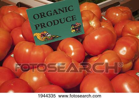 Stock Photography - tomatoes with a sign labeled organic produce; waterloo quebec canada. Fotosearch