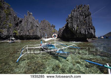 Stock Photography - Traditional Wooden Bangka Boats In The Small Lagoon; Miniloc Island, El Nido, Bacuit Archipelago, Palawan, Philippines. Fotosearch