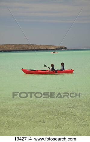 Two Young Boys Paddling In A Red Boat At Los Islotes National Marine Park Espiritu Santo Island; La Paz Baja California Mexico View Large Photo Image Picture - Two Young Boys Paddling In A Red Boat At Los Islotes National Marine Park Espiritu Santo Island; La Paz Baja California Mexico. Fotosearch