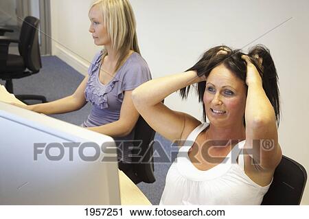 two young women working at computers one pulling at her hair in frustration; south shields tyne and wear england View Large Photo Image Stock Image - two young women working at computers one pulling at her hair in frustration; south shields tyne and wear england. Fotosearch