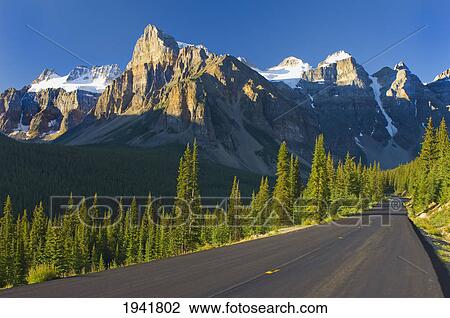 View Of Glacial Mountains And Trees Along The Road To Lake Moraine In Banff National Park; Alberta Canada View Large Photo Image Stock Image - View Of Glacial Mountains And Trees Along The Road To Lake Moraine In Banff National Park; Alberta Canada. Fotosearch