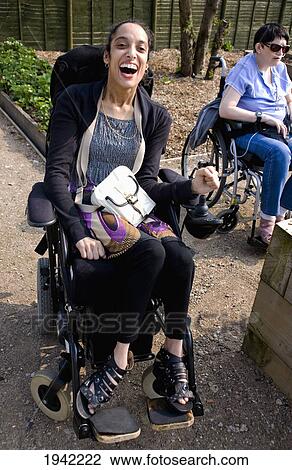 Stock Image - Woman Having Fun Despite Her Physical Disabilities; Bolton Lancashire England. Fotosearch