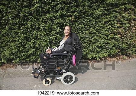 Stock Photo - Woman Operating Her Wheelchair; Bolton Lancashire England. Fotosearch