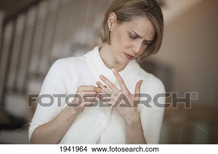 Woman Worried About Marriage And Taking Off Her Wedding Ring; Jordan Ontario Canada View Large Photo Image Picture - Woman Worried About Marriage And Taking Off Her Wedding Ring; Jordan Ontario Canada. Fotosearch