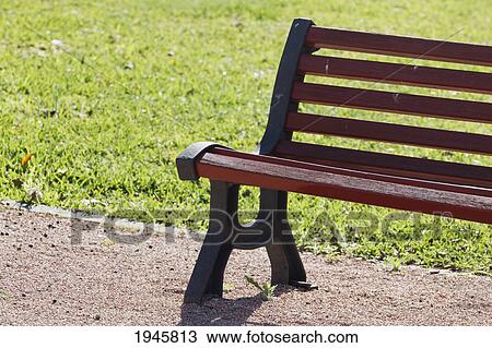 Stock Image - wooden bench on a path; torremolinos malaga andalusia spain. Fotosearch