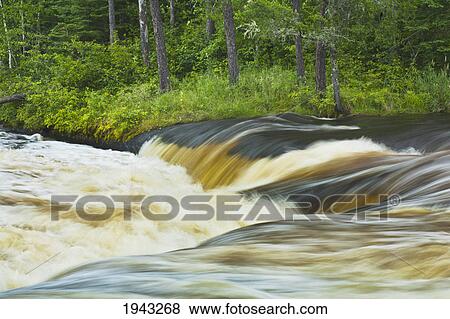 Yellow Spring Water Pouring Over Pine Point Rapids; Pinawa Manitoba Canada View Large Photo Image Stock Photo - Yellow Spring Water Pouring Over Pine Point Rapids; Pinawa Manitoba Canada. Fotosearch