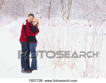Young Couple Hugging During A Snowfall; St. Paul Minnesota United States Of America View Large Photo Image Stock Photo - Young Couple Hugging During A Snowfall; St. Paul Minnesota United States Of America. Fotosearch