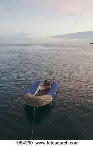 Stock Image - a boat mooring in the water off the coast; puerto baquerizo moreno, san cristobal, galapagos, equador. Fotosearch