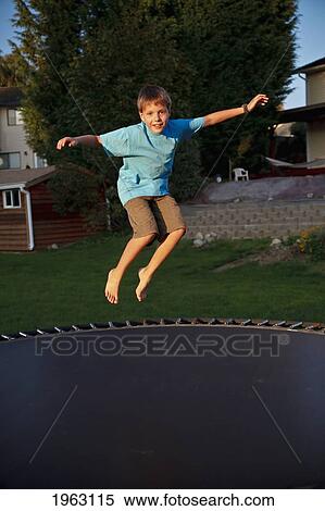 Stock Photography - a boy jumping on a trampoline; ferndale, washington, united states of america. Fotosearch