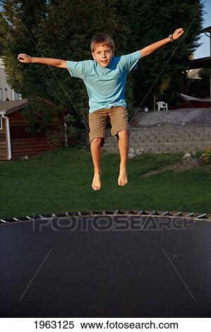 a boy jumping on a trampoline; ferndale, washington, united states of america View Large Photo Image Stock Photography - a boy jumping on a trampoline; ferndale, washington, united states of america. Fotosearch