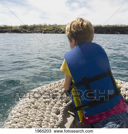 a boy wearing a lifejacket takes a boat ride; galapagos equador View Large Photo Image Stock Image - a boy wearing a lifejacket takes a boat ride; galapagos equador. Fotosearch