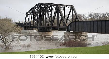 a bridge crossing assiniboine river with high waters after a flood; headingley, manitoba, canada View Large Photo Image Stock Image - a bridge crossing assiniboine river with high waters after a flood; headingley, manitoba, canada. Fotosearch