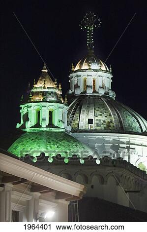 Stock Image - a building with a domed roof illuminated by green light; quito, equador. Fotosearch
