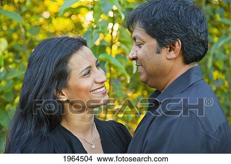 Picture - a couple enjoying time together in a park; edmonton alberta canada. Fotosearch