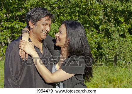 a couple enjoying time together in a park; edmonton, alberta, canada View Large Photo Image Stock Photo - a couple enjoying time together in a park; edmonton, alberta, canada. Fotosearch