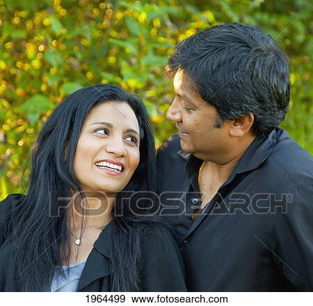 Stock Photo - a couple enjoying time together in a park; edmonton alberta canada. Fotosearch