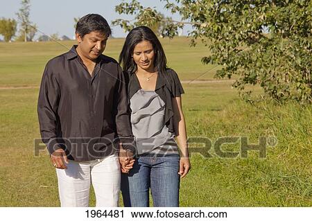 a couple walking and talking in a park; edmonton, alberta, canada View Large Photo Image Stock Image - a couple walking and talking in a park; edmonton, alberta, canada. Fotosearch
