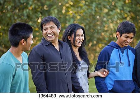 a family enjoying time together in a park; edmonton, alberta, canada View Large Photo Image Stock Photo - a family enjoying time together in a park; edmonton, alberta, canada. Fotosearch