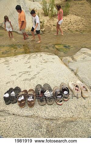 a family leaves their shoes on the shore and walks in the shallow water at the sierra la laguna biosphere reserve; baja california sur mexico View Large Photo Image Stock Photo - a family leaves their shoes on the shore and walks in the shallow water at the sierra la laguna biosphere reserve; baja california sur mexico. Fotosearch