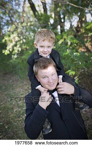 Stock Photo - a father and son both wearing tuxedos and bow ties; edmonton alberta canada. Fotosearch