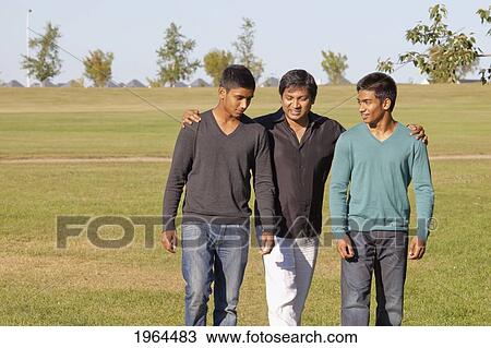 a father and two sons walking in a park; edmonton, alberta, canada View Large Photo Image Stock Image - a father and two sons walking in a park; edmonton, alberta, canada. Fotosearch