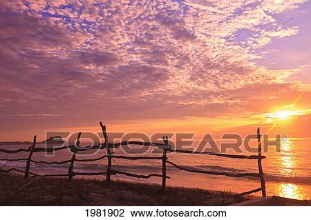 a fence along the water's edge at sunrise at cabo pulmo; baja california sur mexico View Large Photo Image Stock Image - a fence along the water's edge at sunrise at cabo pulmo; baja california sur mexico. Fotosearch
