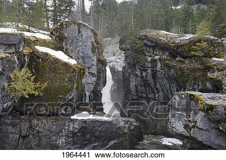 Stock Image - a frozen waterfall between large rocks in jasper national park; alberta, canada. Fotosearch
