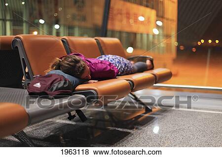 a girl sleeping on chairs at an airport; beijing, china View Large Photo Image Stock Photo - a girl sleeping on chairs at an airport; beijing, china. Fotosearch