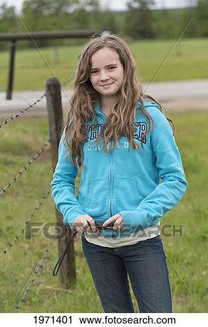 a girl stands holding her camera; alberta canada View Large Photo Image Stock Image - a girl stands holding her camera; alberta canada. Fotosearch