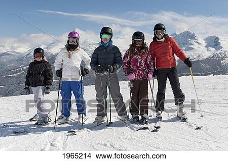 a group of skiers posing with the mountains in the background; whistler british columbia canada View Large Photo Image Picture - a group of skiers posing with the mountains in the background; whistler british columbia canada. Fotosearch
