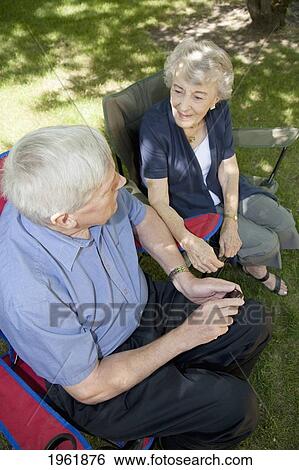 a man and a woman sit talking; edmonton, alberta, canada View Large Photo Image Stock Photograph - a man and a woman sit talking; edmonton, alberta, canada. Fotosearch